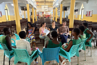 Public health students sitting in a circle with Ghana university students