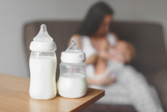 Milk in baby bottles on table