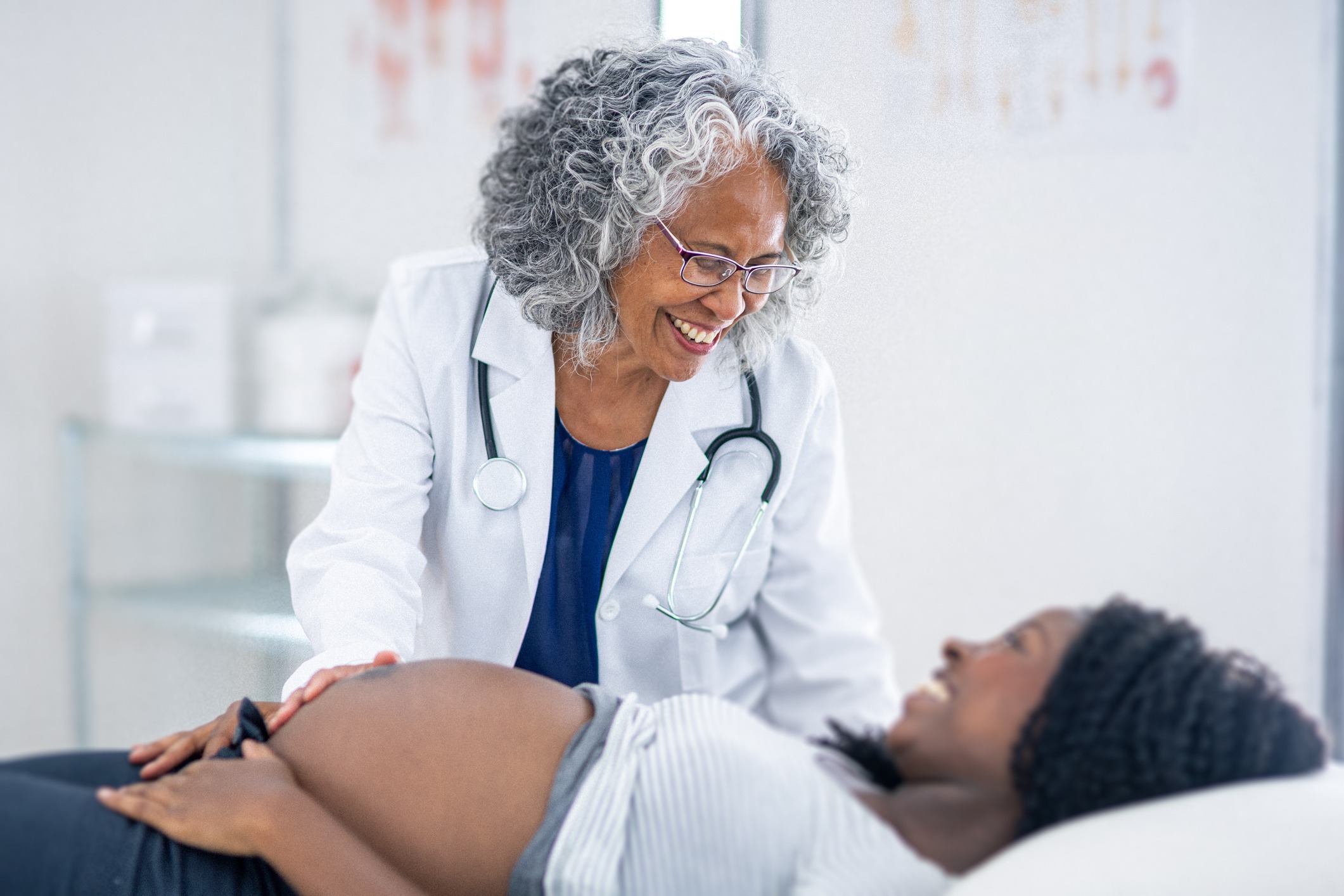 Doctor looking at patient lying on table